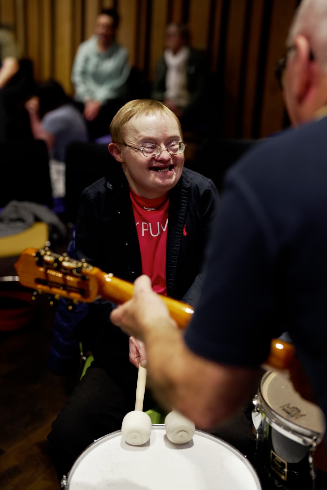 Beneficiary smiling during a drumming session